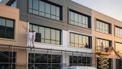 Professional commercial painters finishing an office exterior in Chandler, AZ